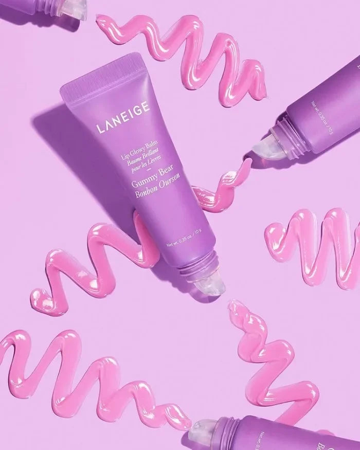 Laneige Gummy Bear Lip Glowy Balm with glossy pink lip treatment swirls on a purple background.
