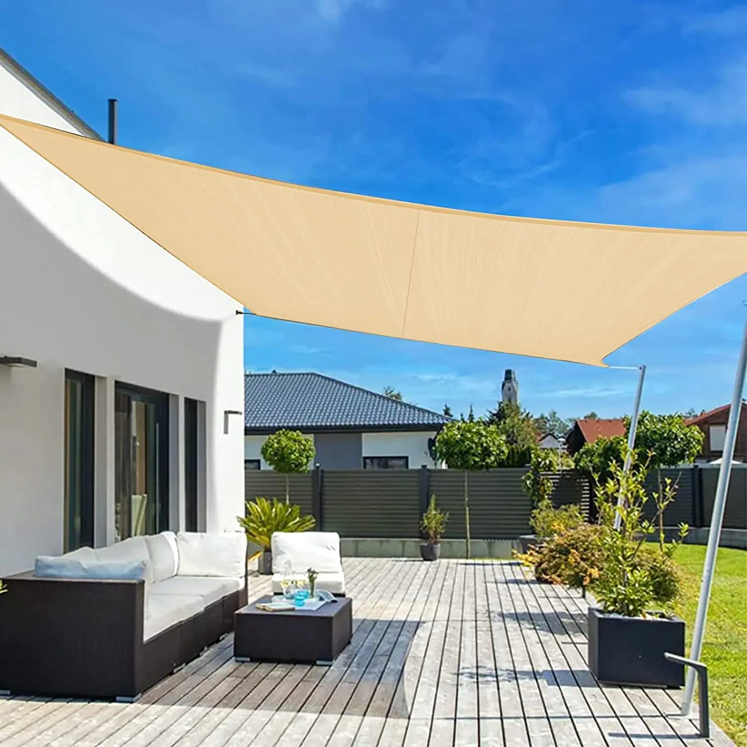 Beige waterproof rectangle sun shade sail canopy stretched over a patio with corner grommets