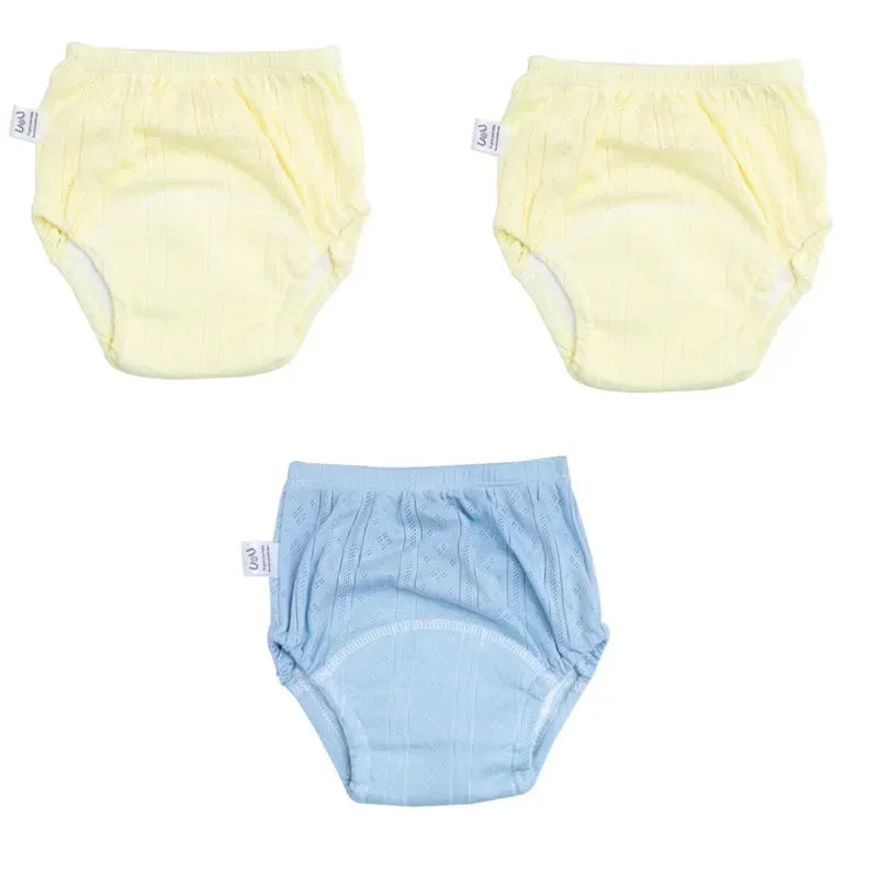Three-pack of baby cotton training diaper pants in yellow and blue, soft absorbent baby care underwear.