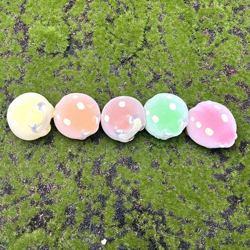 Cute, soft flocked, colorful Yell World rain frog squeeze toys on moss, perfect for sensory play and kawaii decor.