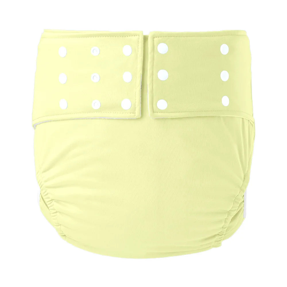 Reusable pale yellow cloth baby diaper with adjustable snap buttons for customized fit and baby care comfort.