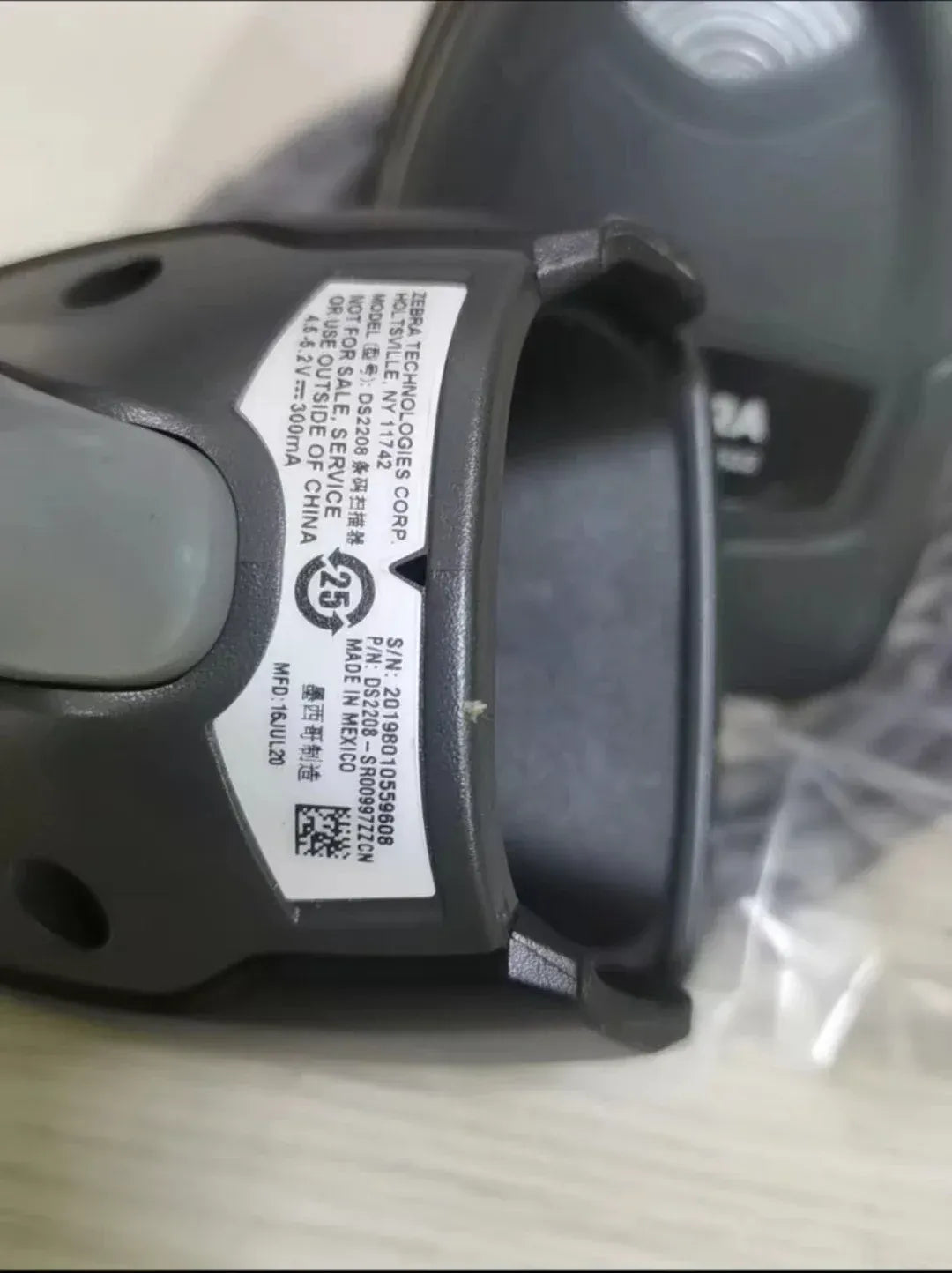 2D wired handheld scanner close-up of side label and connector area