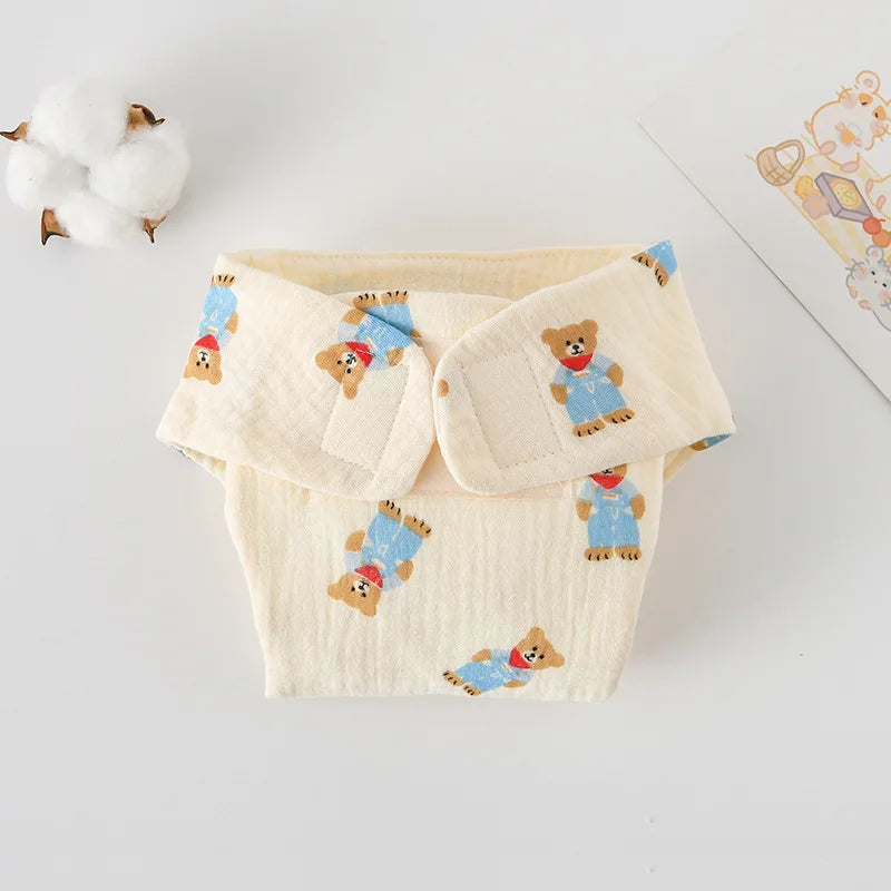 Reusable baby cloth diaper cover with cream cotton fabric and cute teddy bear print. Soft baby care essential.