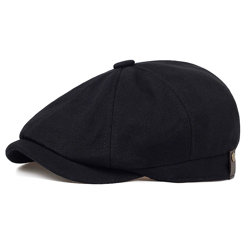 Tidesmit black cotton flat cap, a structured newsboy-style beret with a small side button detail.