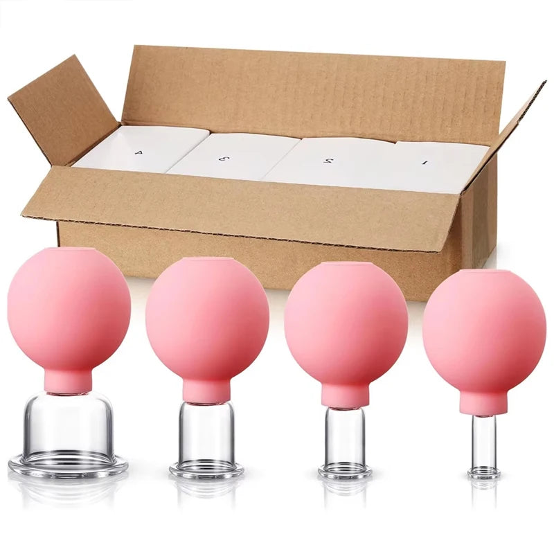 Four pink silicone and glass facial cupping massage tools of varying sizes, displayed in front of a cardboard box.