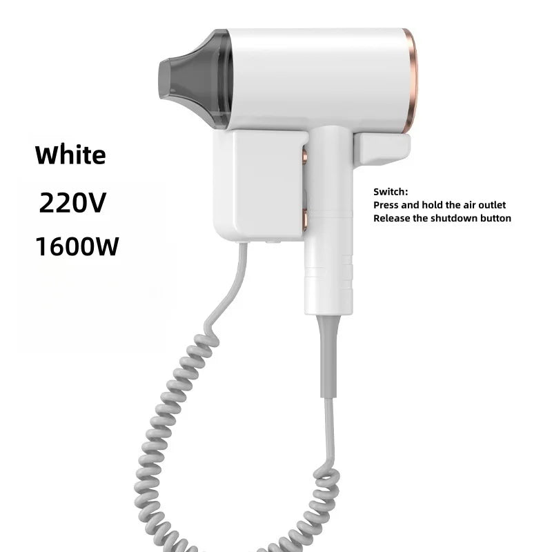 White 1600W wall-mounted hotel hair dryer with nozzle attachment, coiled cord, and press-to-start safety design.