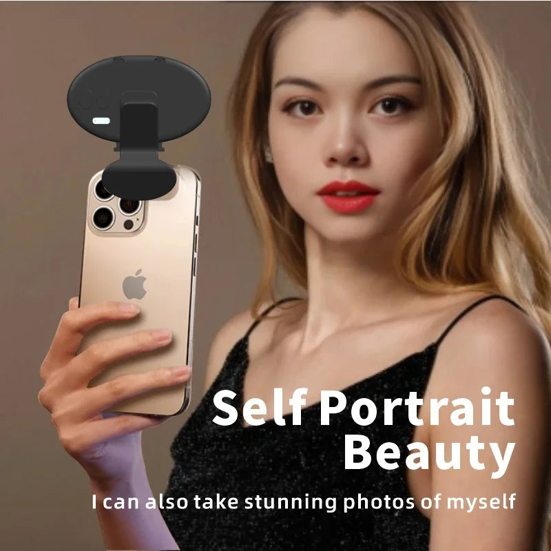 Black oval clip-on LED selfie light attached to a smartphone for better portrait lighting.