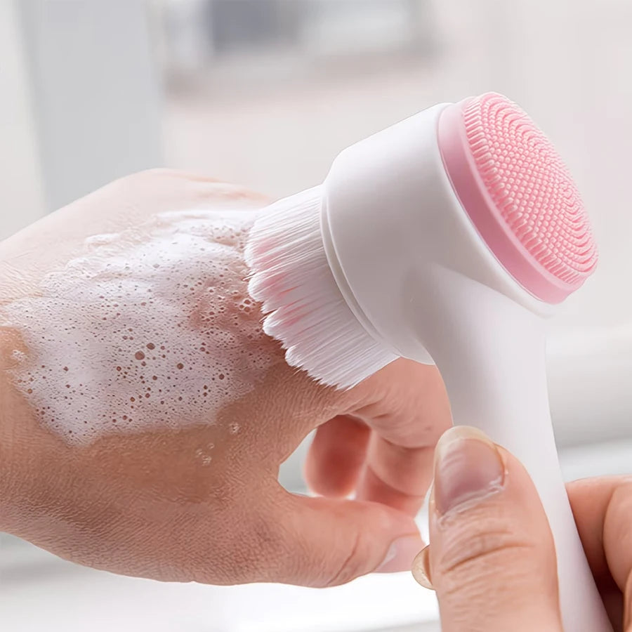 Double-sided facial cleansing brush with soft bristles and silicone exfoliating scrubber for deep pore cleaning.