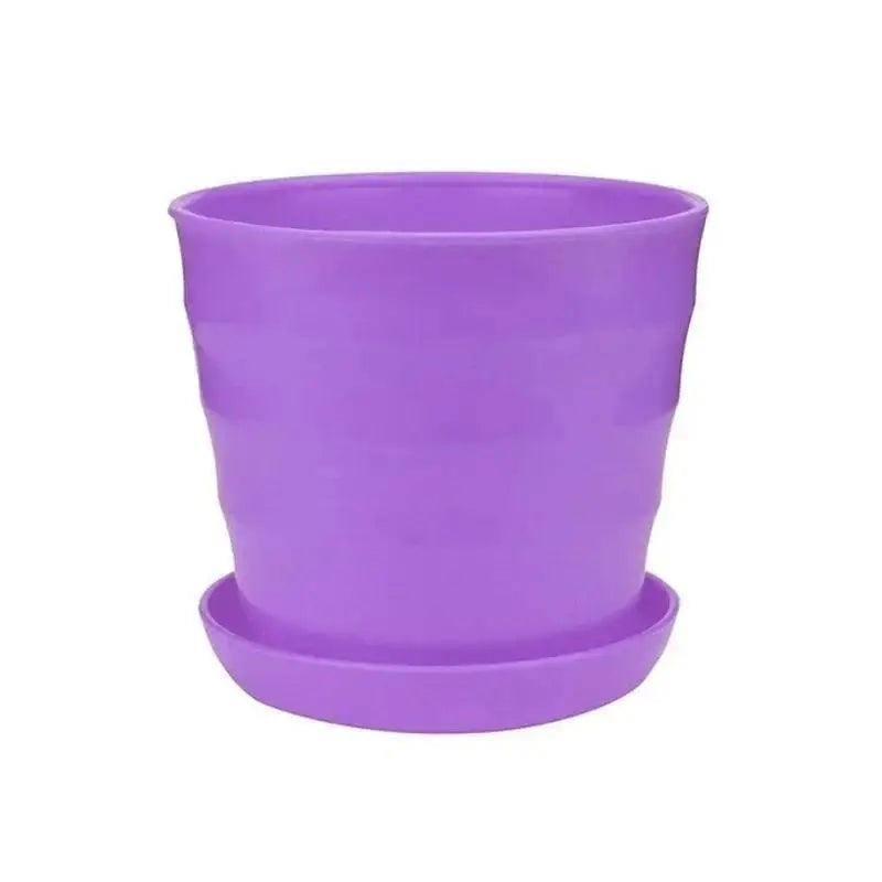 Purple plastic flower pot with matching saucer, wide rim and rounded sides