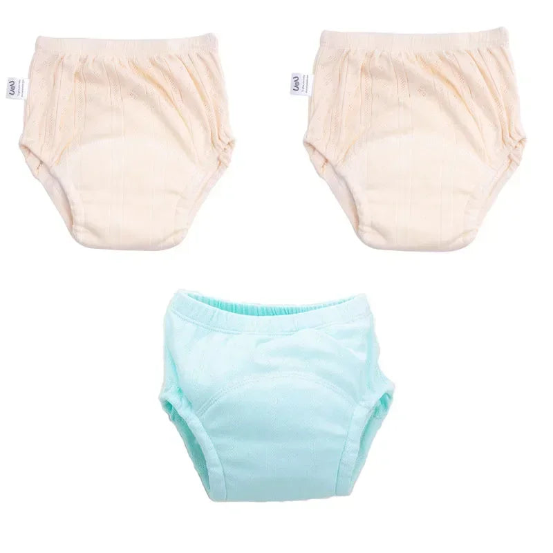 Three-pack of baby cotton training diapers in beige and light blue, soft baby care essentials for potty training.