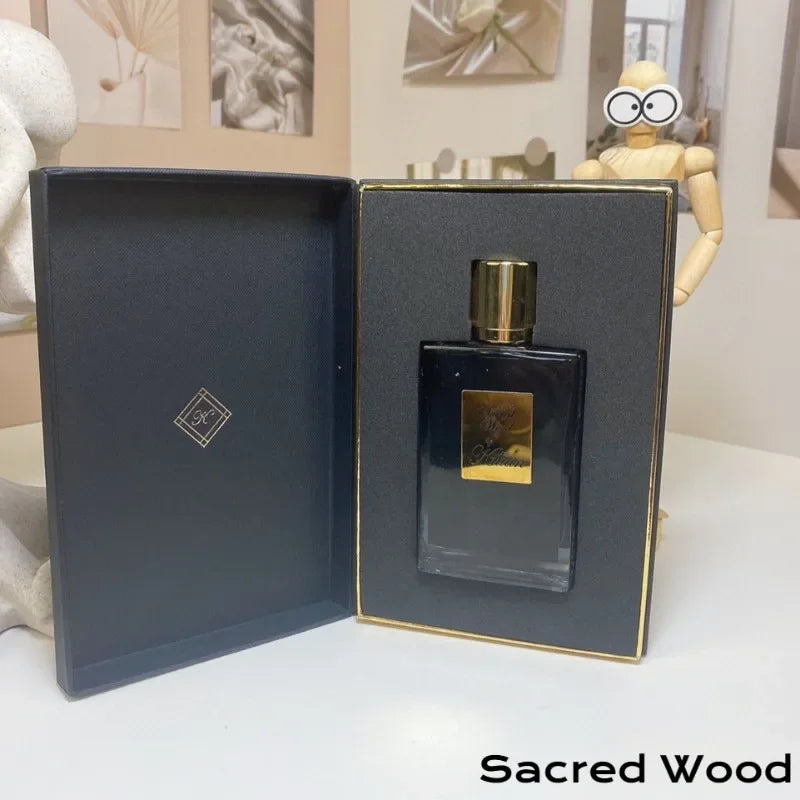 Kilian Sacred Wood perfume 50ml in a sleek black glass bottle with gold cap, presented in a luxury black gift box.