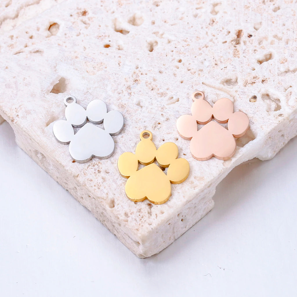 Gold, silver, and rose gold stainless steel dog paw charms for DIY pet-themed jewelry necklaces and bracelets.