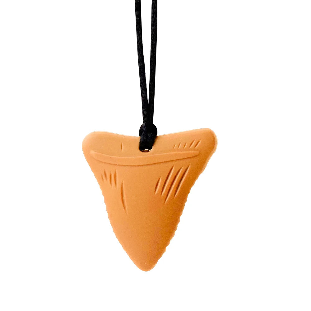 Tan silicone shark tooth baby teething toy necklace.