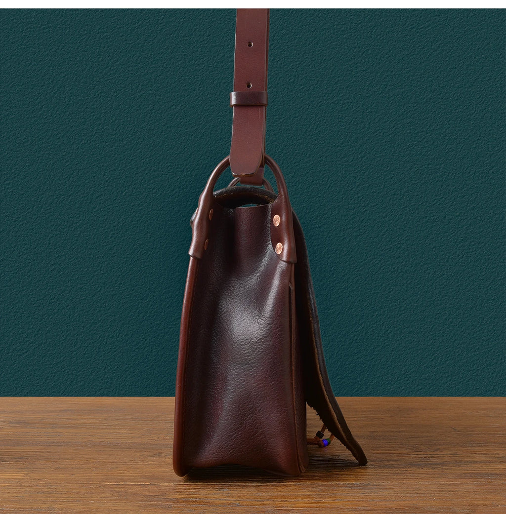 PNDME vintage handmade dark brown genuine cowhide leather messenger bag with adjustable shoulder strap and rivet detail.