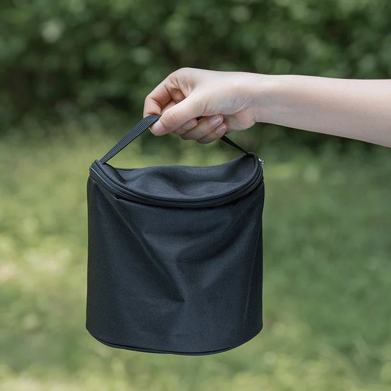 Small black carrying bag with loop handle for camping cookware