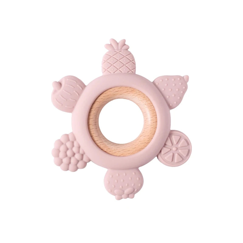 Pink fruit silicone and wood baby teething ring for soothing sore gums.