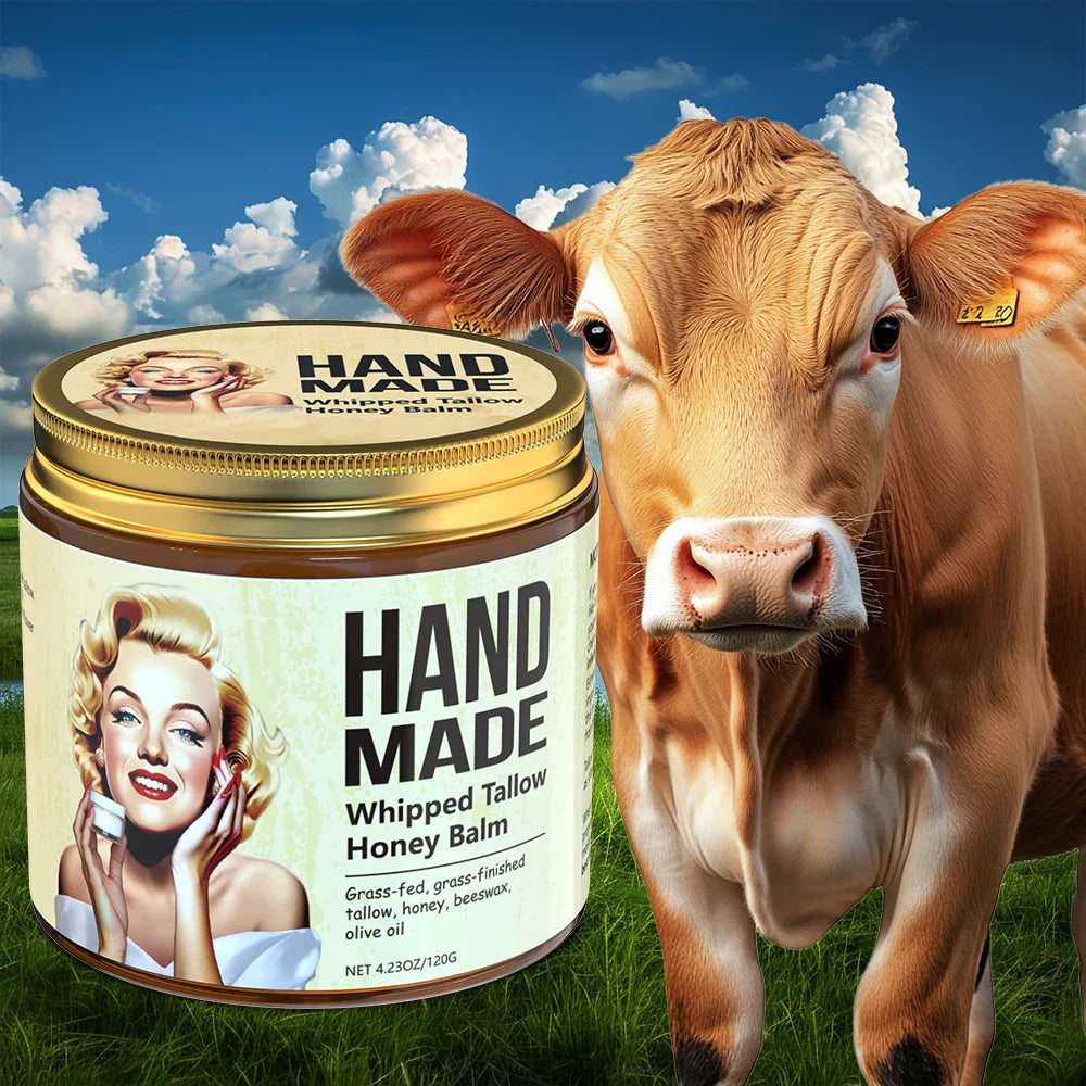 ENVISHA handmade whipped tallow honey face cream in a jar next to a cow on a pasture, for firming and moisturizing.