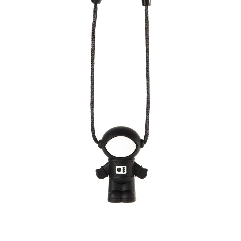 Black silicone astronaut baby teething toy on a matching lanyard for soothing sore gums.