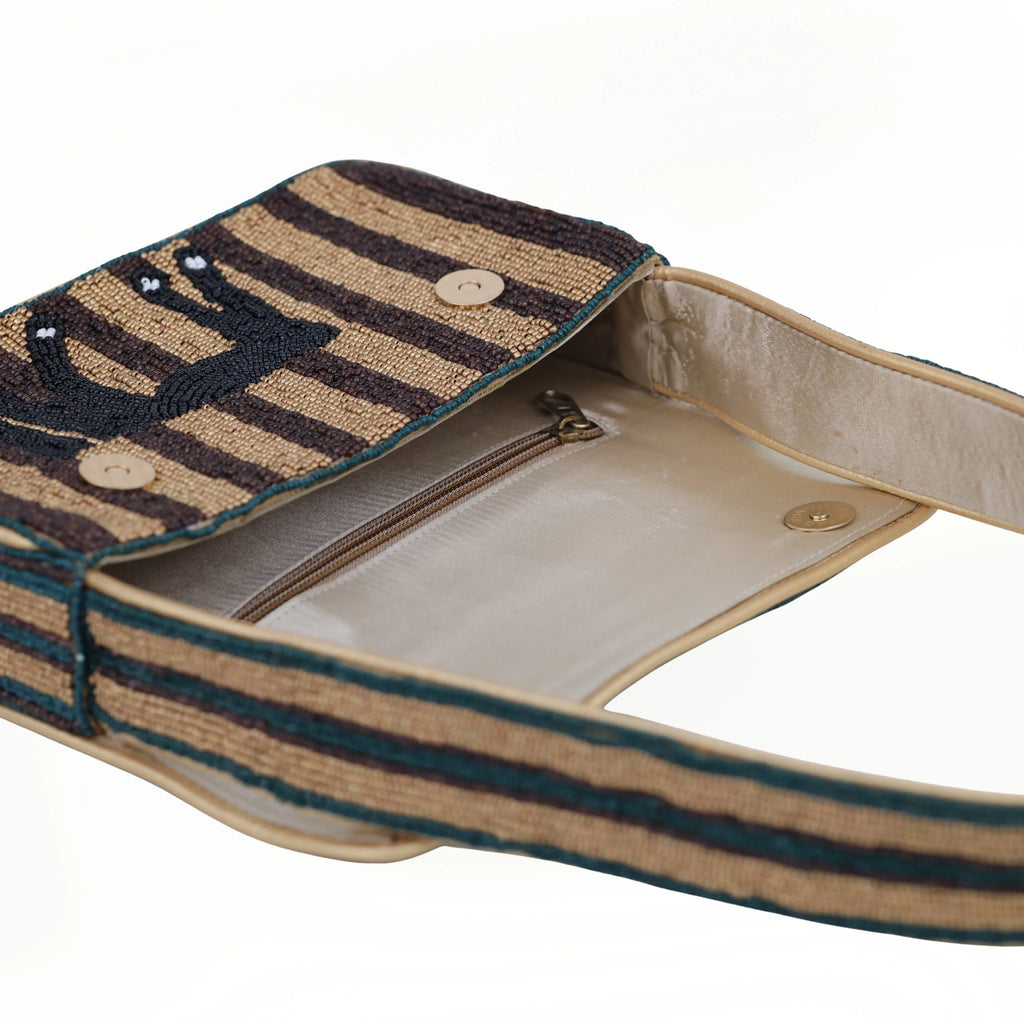Beaded bohemian shoulder bag with brown horse pattern, stripe design, single strap, and cream silk-lined interior.