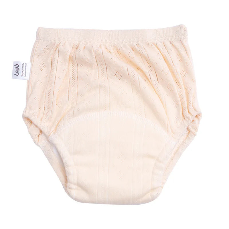 UOU baby care training diaper in light cream, soft cotton fabric with a pointelle knit design.