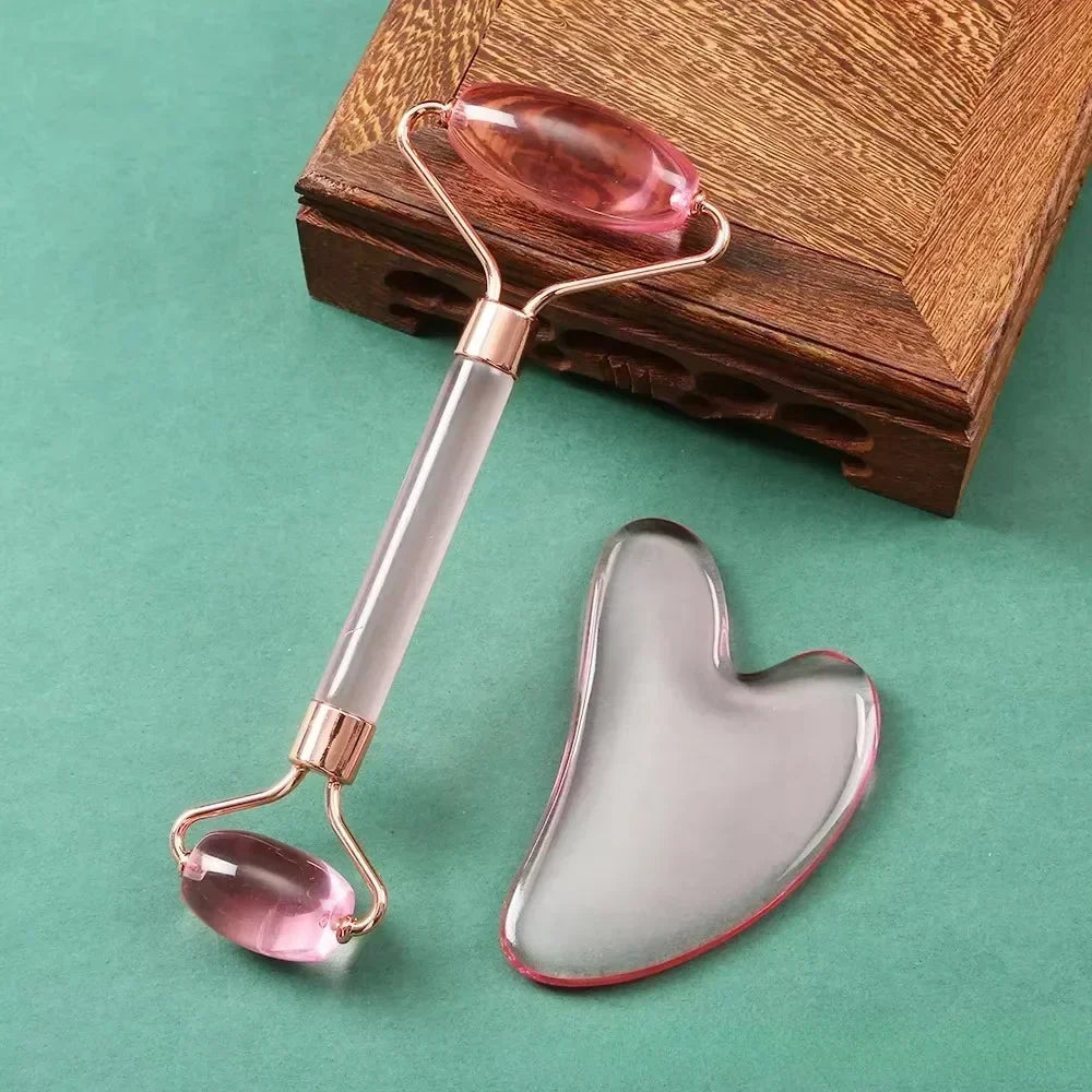 Pink resin jade roller and heart-shaped gua sha scraper set for facial massage, anti-aging, and skin lifting.
