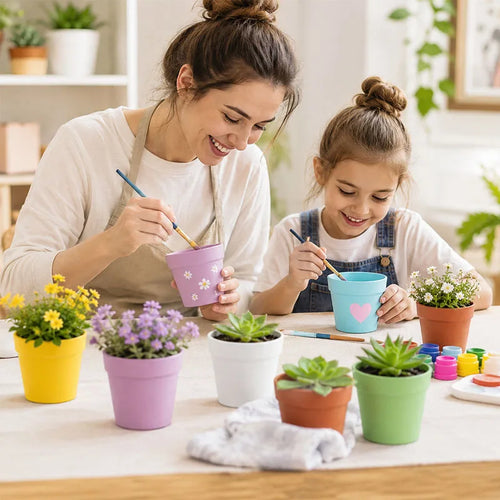 Mini round plastic flower pots with succulents in pastel yellow, purple, green and terracotta