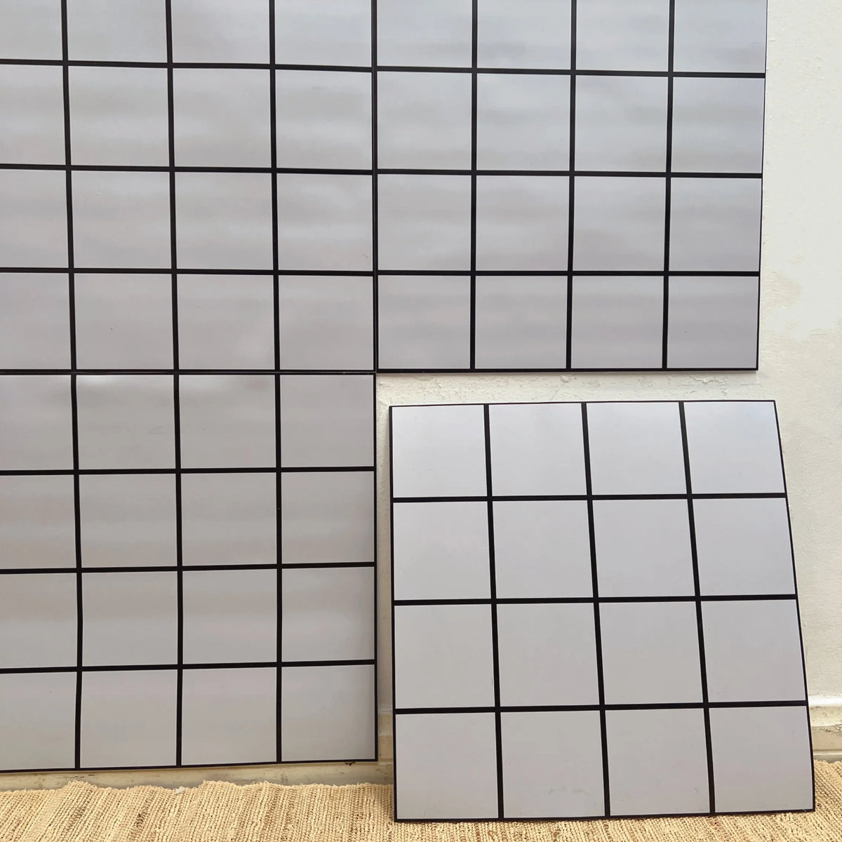 Peel-and-stick square tile backsplash, white tiles with black grid borders
