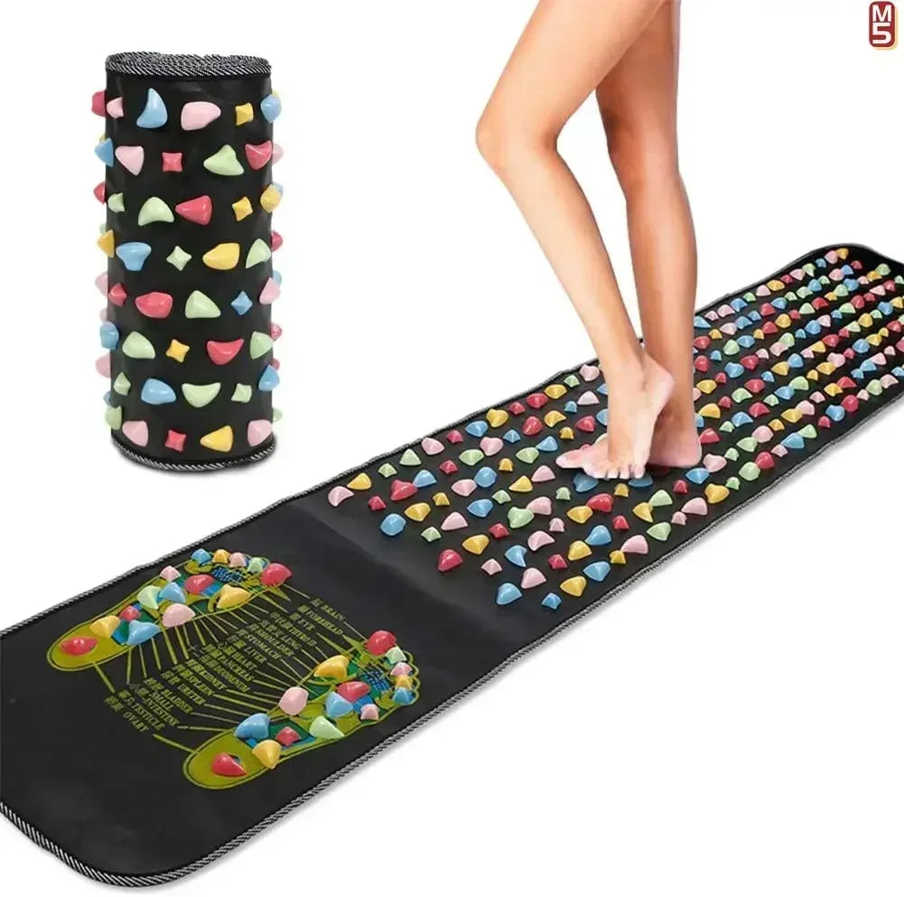 Person walking on a black acupressure reflexology massage pad with colorful pressure stones and foot map chart.