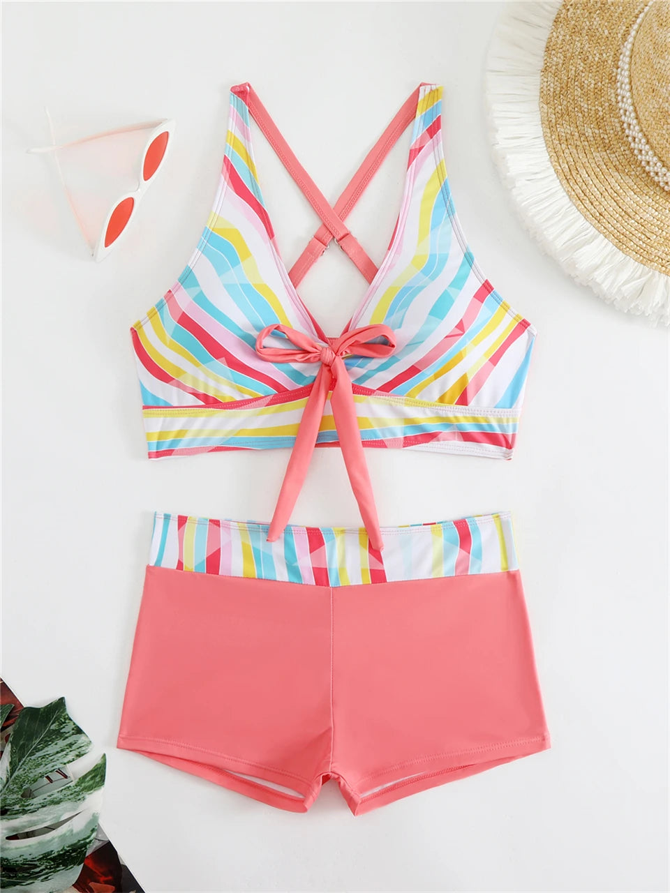 Tidesmit high-waist bikini with a multi-colored striped print top, crisscross back, bow tie front, and coral shorts.