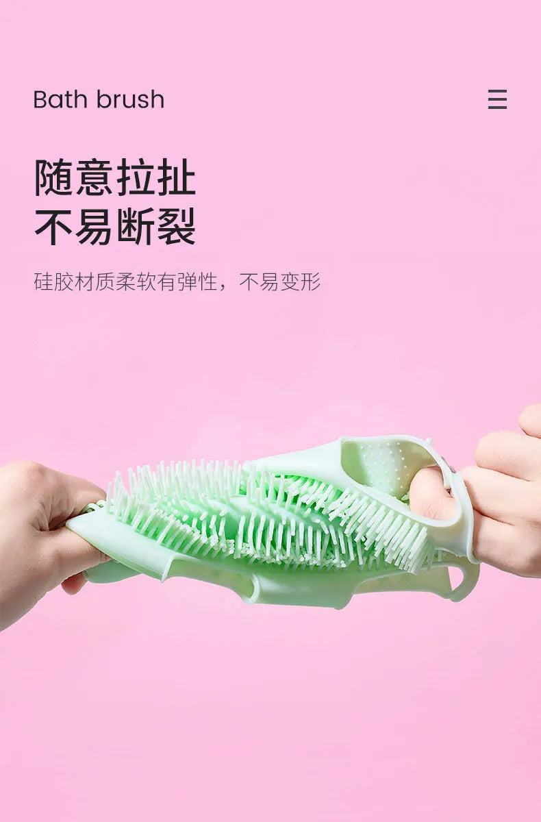 Flexible green silicone pet bath brush glove for gentle grooming, deep cleaning, and massage on a pink background.