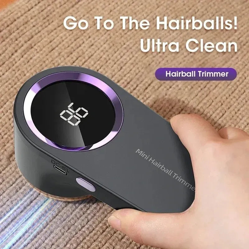 Hairball trimmer with digital battery display removing lint and fuzz from a knitted sweater.