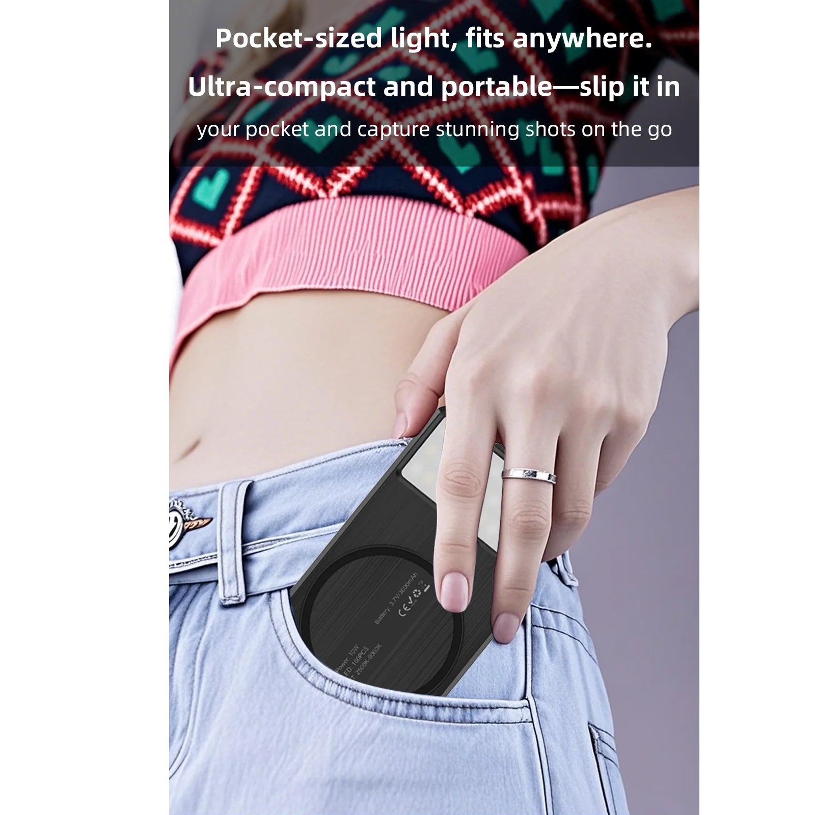 Compact black rectangular LED video light being placed into a blue jeans pocket for portable photography lighting.