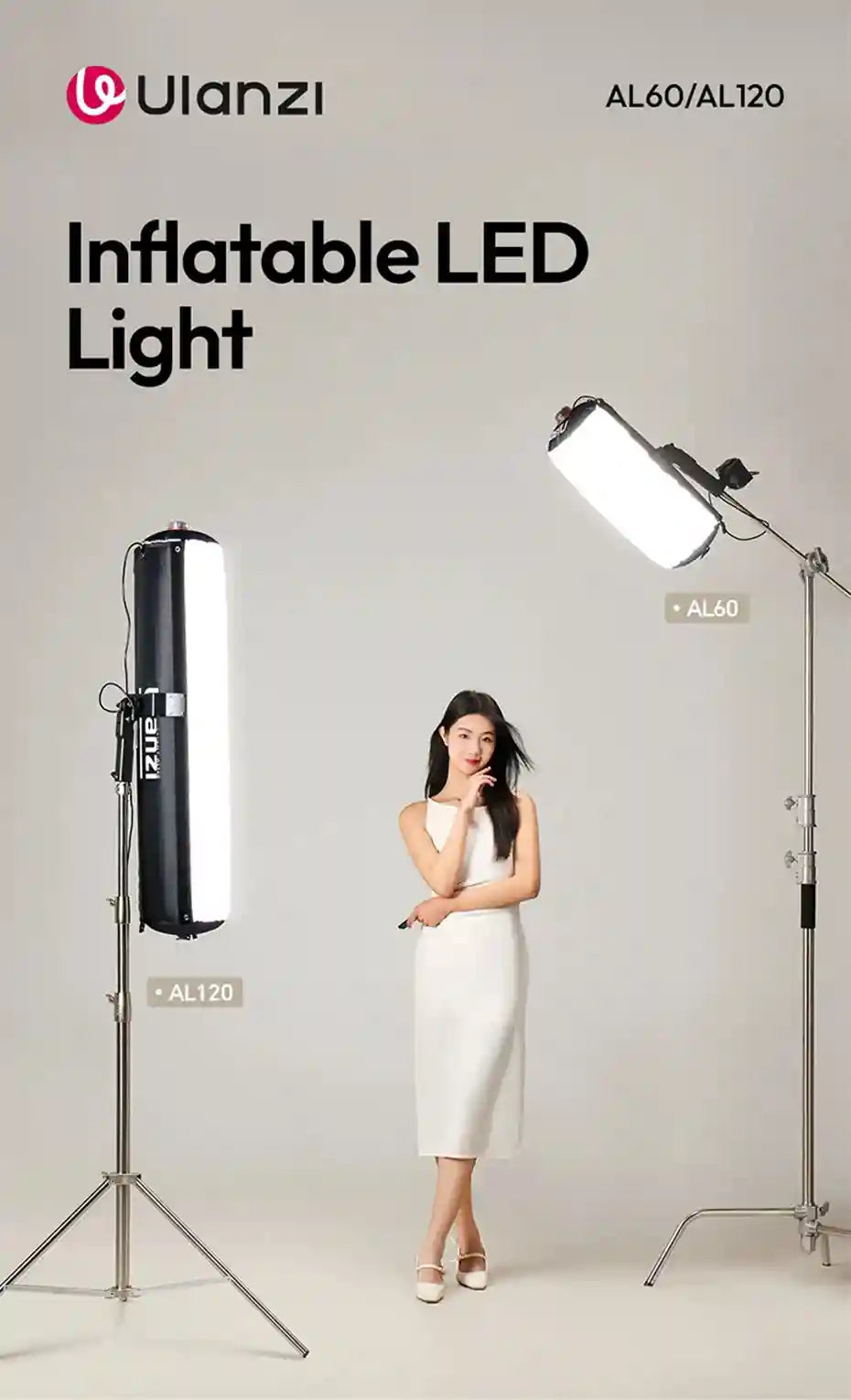 Two long, inflatable white LED studio lights on metal stands, illuminating a woman posing in a photography studio.