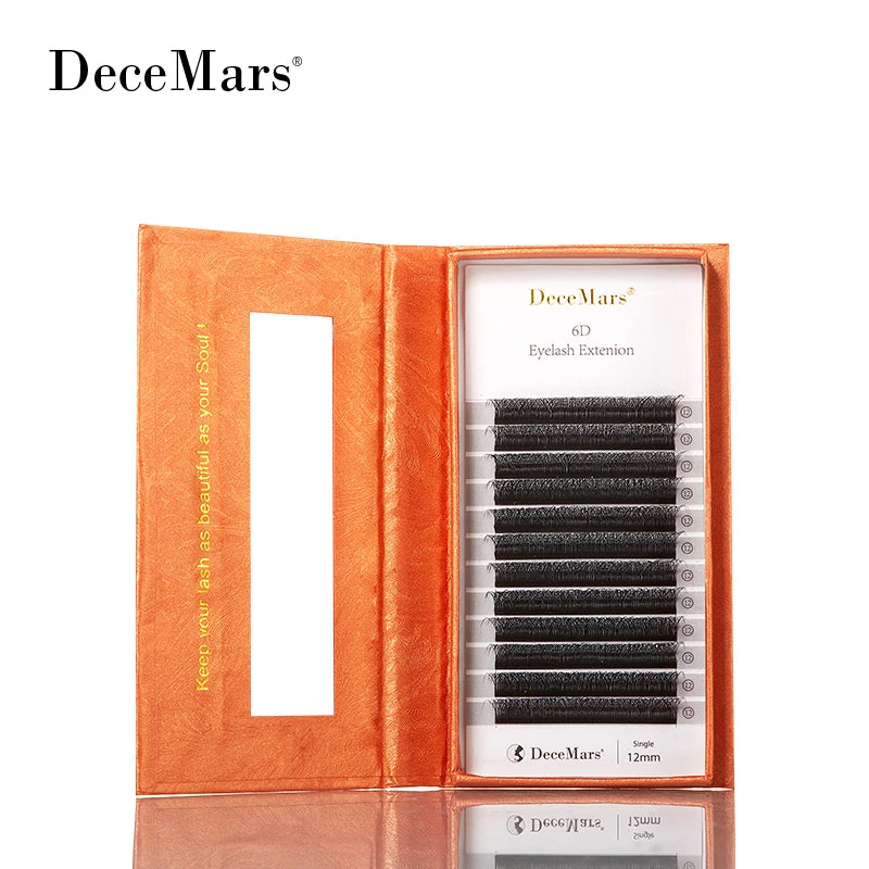 DeceMars 6D W-shaped black eyelash extensions in an open, textured orange cardboard case.