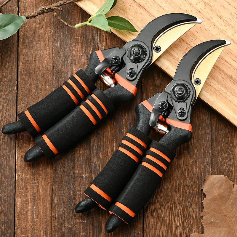 Two pruning shears with black-and-orange grips and curved gold blades, side by side