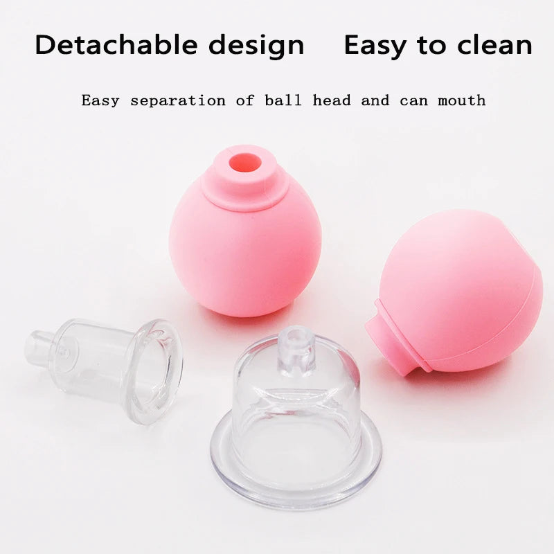 Two pink silicone vacuum balls and two clear plastic cupping heads displayed as detachable facial massage tools.