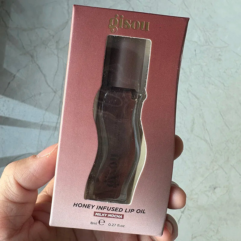 Gisou Honey Infused Lip Oil in Milky Mocha, a moisturizing brown lip gloss in original packaging.