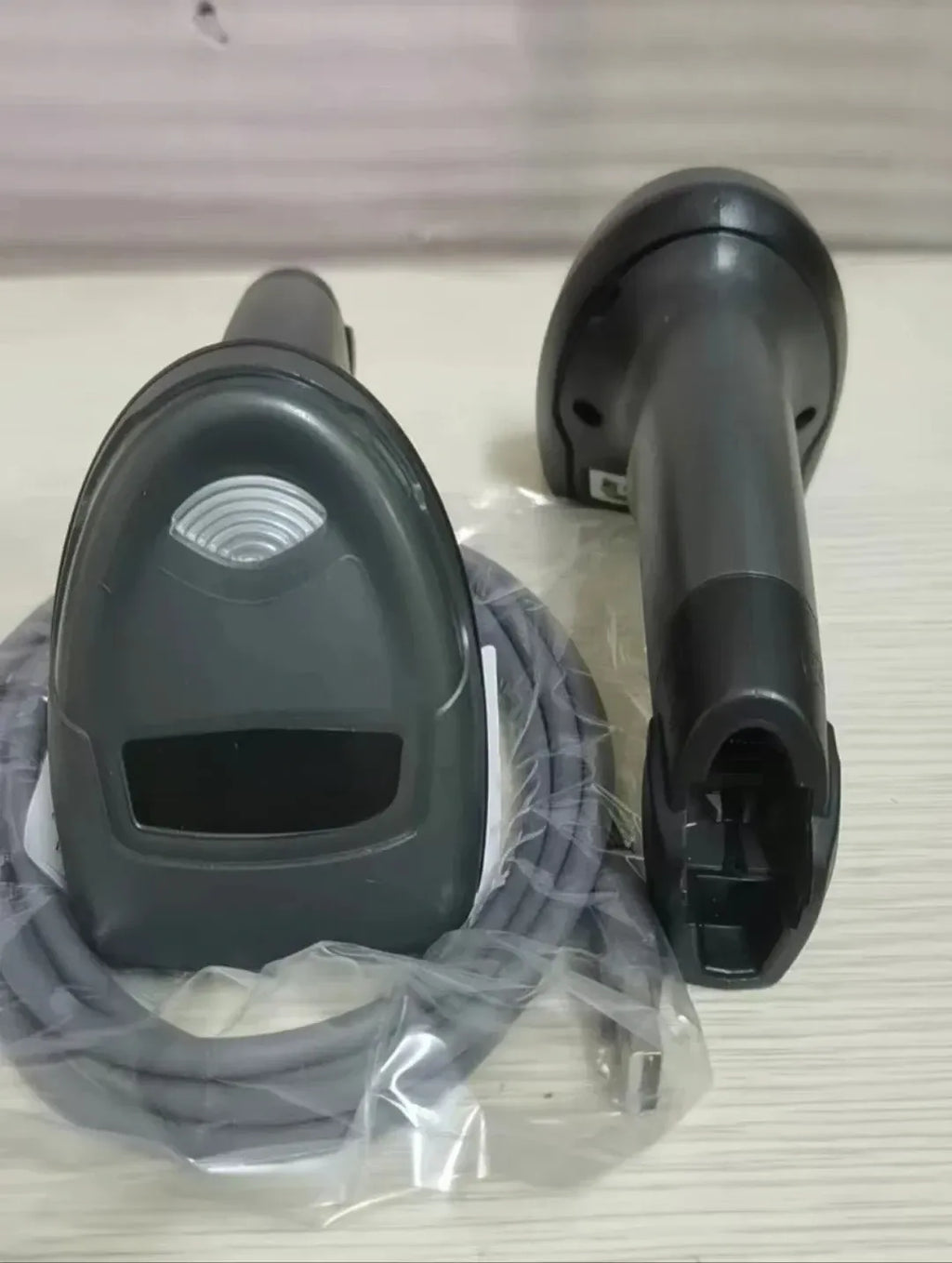 Two 2D wired handheld barcode scanners with cable and accessories in packaging