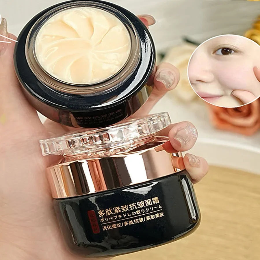 A hand holds an open black and rose gold cosmetic jar filled with swirl-textured beige face cream.