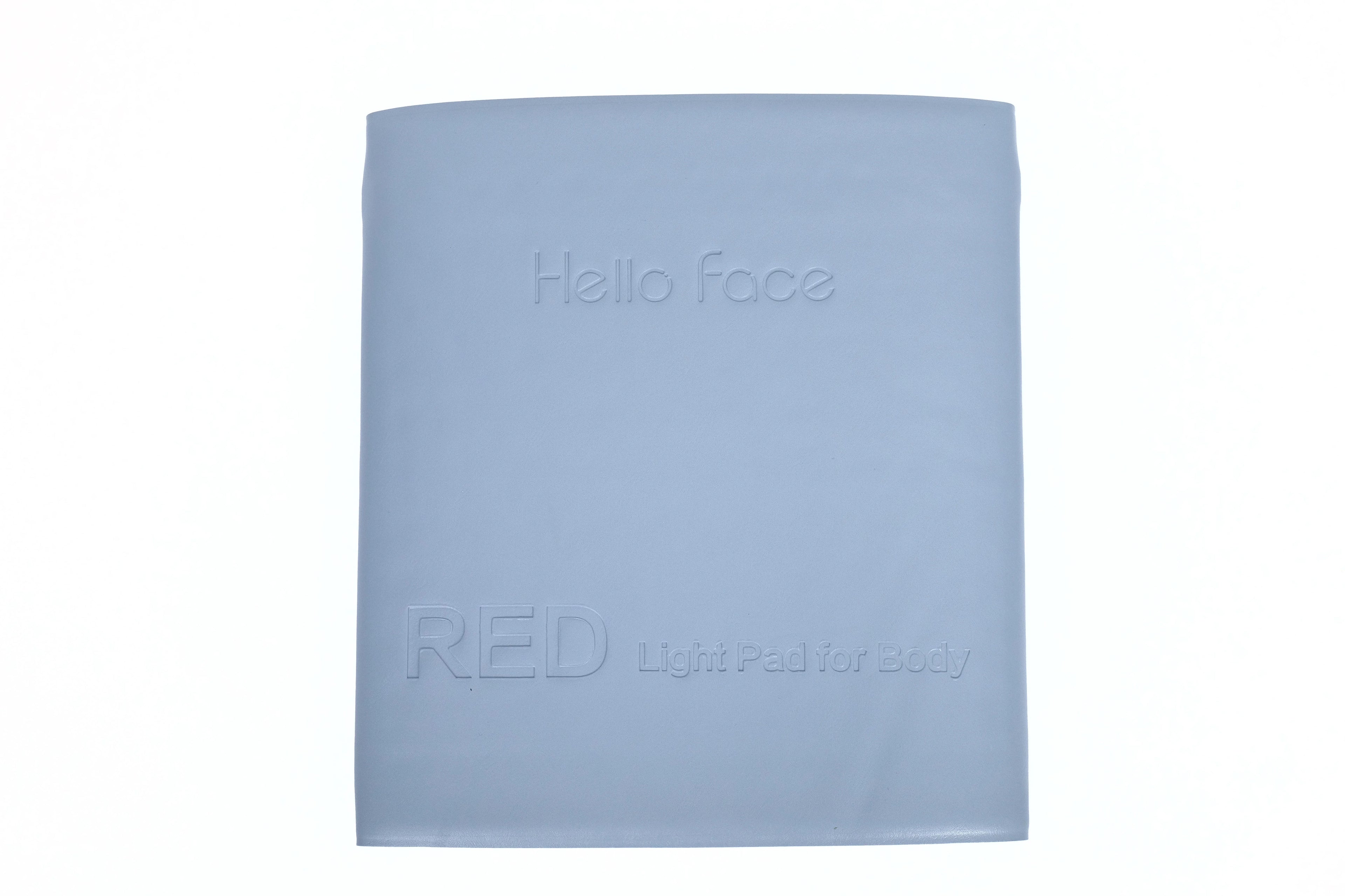 Hello Face light grey rectangular therapy mat with embossed brand name and text, isolated on white background.
