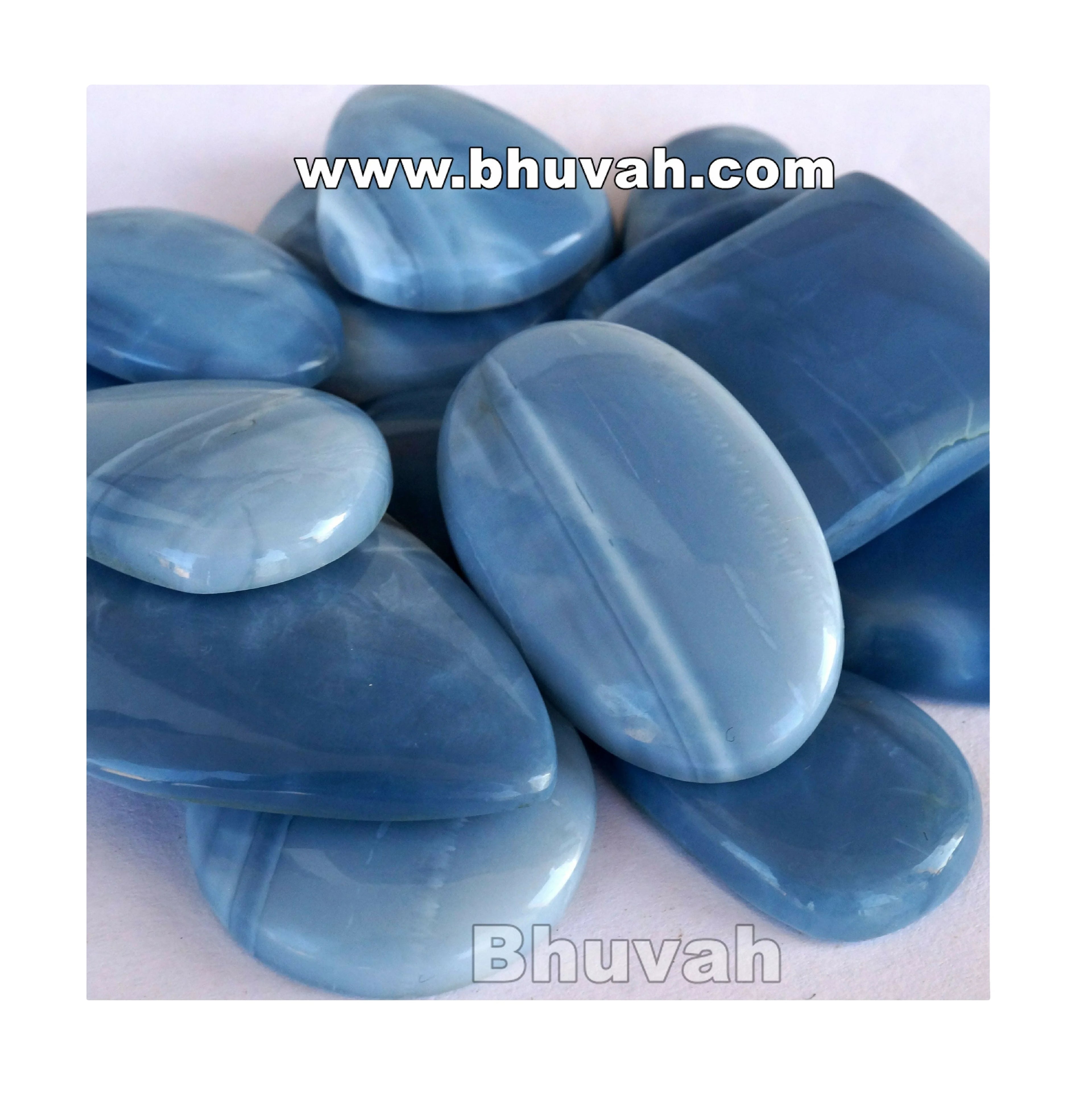 Blue opal cabochon gemstones, close-up oval stones in light and dark blue