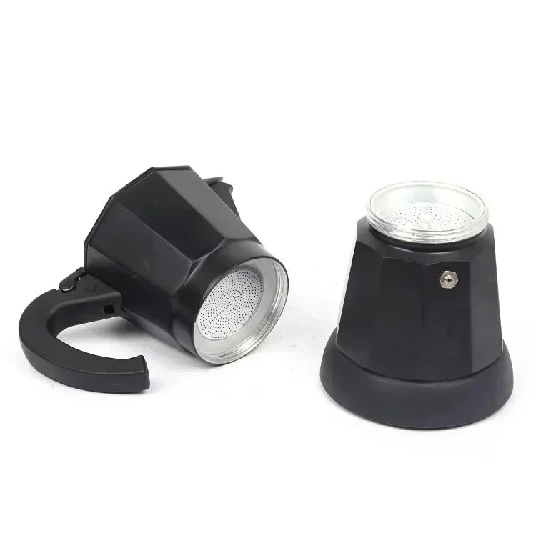 Black aluminum moka pot disassembled, showing two-piece stovetop espresso maker parts with metal filters and handle.