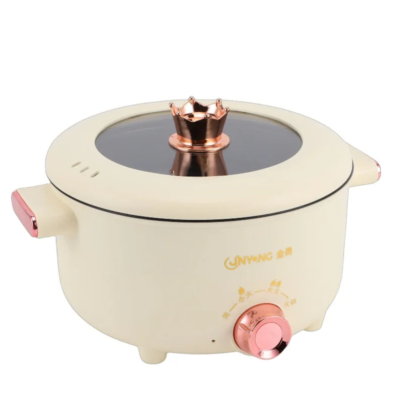 Cream electric cooking pot with copper burner top on black heating plate and front temperature knob