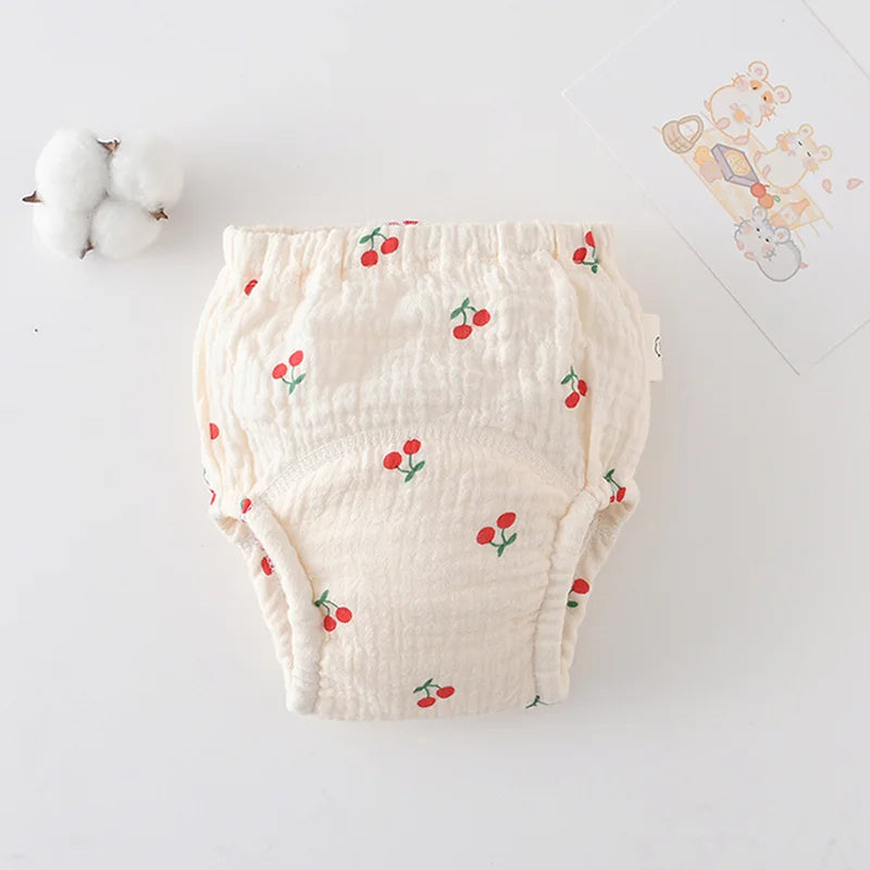 Baby care reusable cloth training diaper with cream and red cherry print pattern.