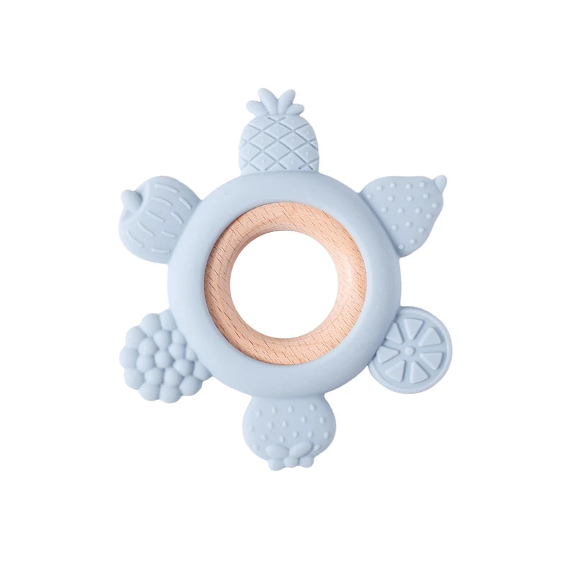 Blue fruit-shaped silicone and wood teething ring for baby teething relief.
