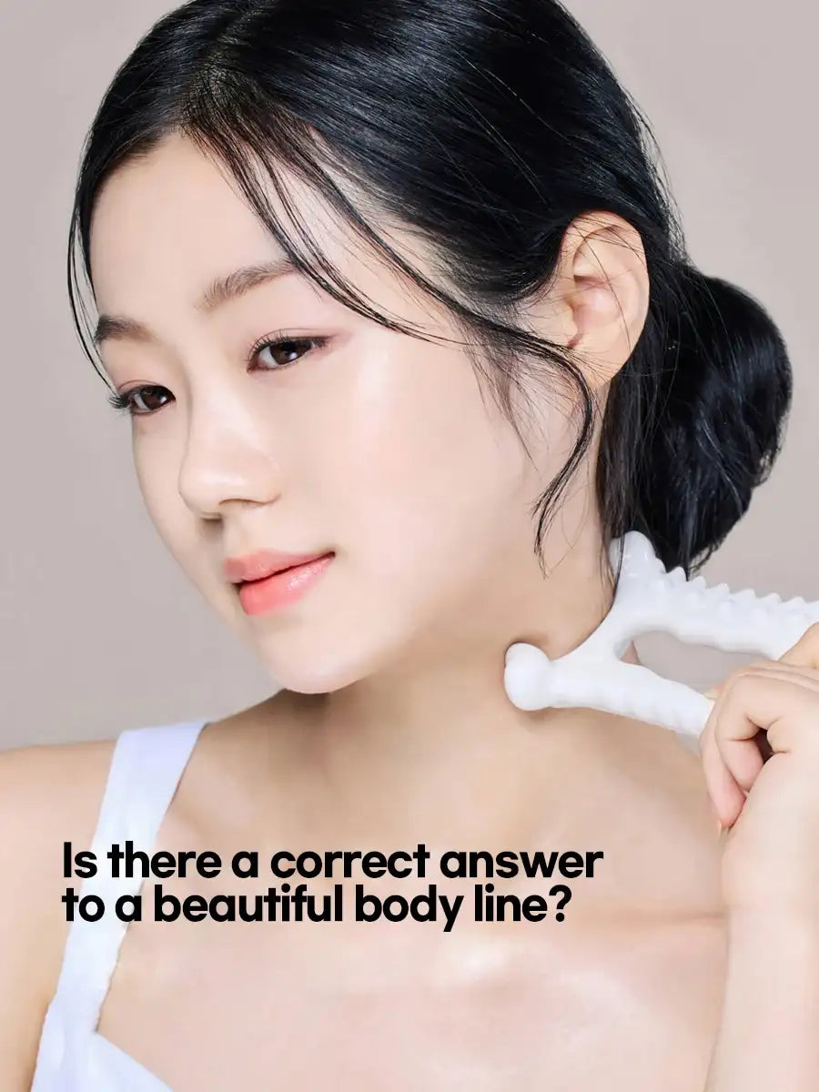 Woman using a white, textured ceramic Y-shaped gua sha tool to massage her neck.