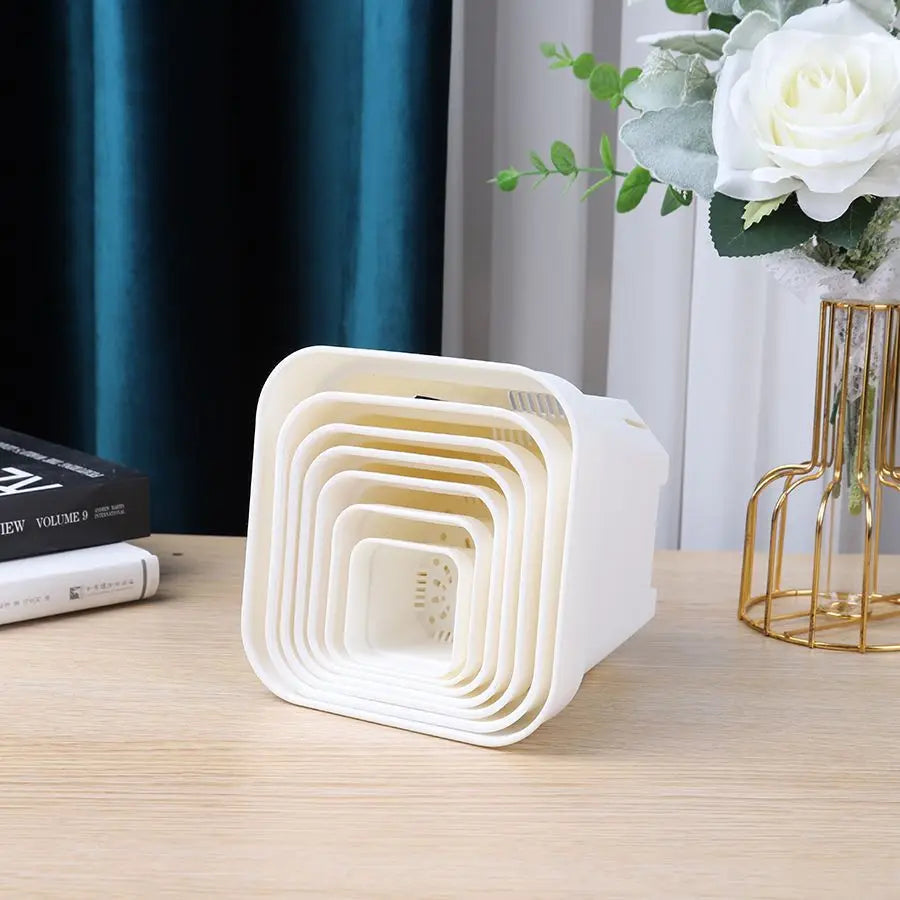 Stacked white square nesting succulent planter pots with drainage holes