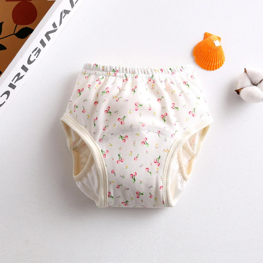 Baby care training underwear with cherry print pattern for toddlers, soft absorbent diaper alternative.