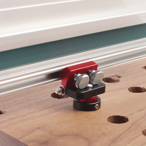 Adjustable track saw hinge dog clamp, red and black with mounting screws on rail