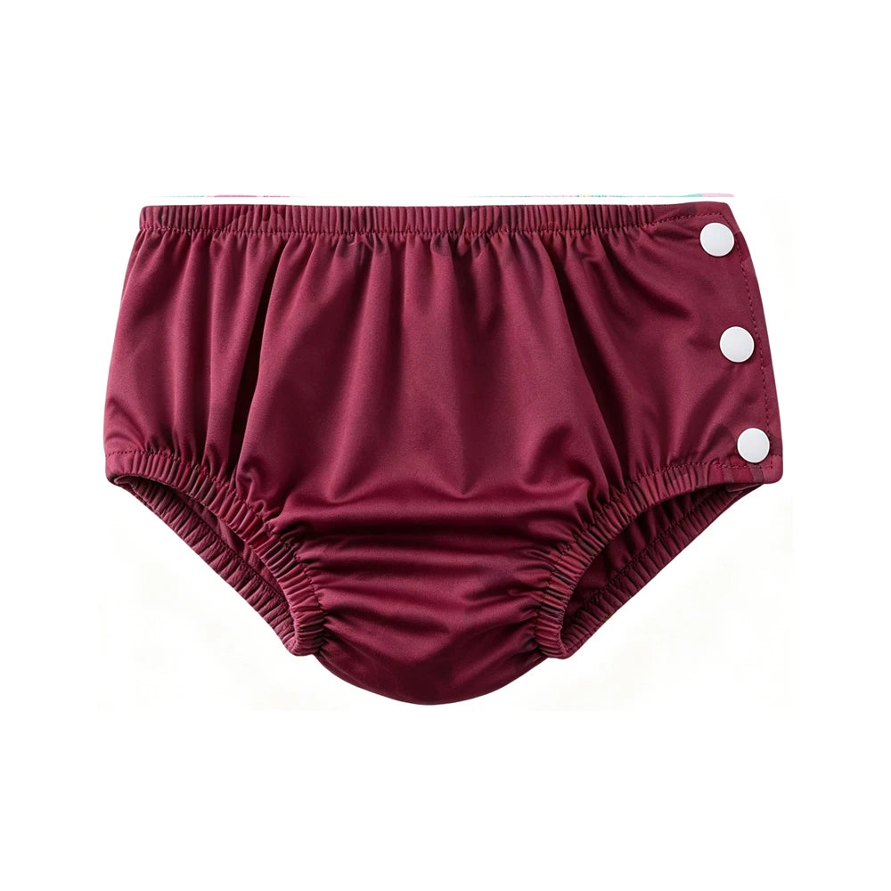 Maroon cloth baby swim diaper with side snap buttons for easy changes. Reusable waterproof diaper for baby care.